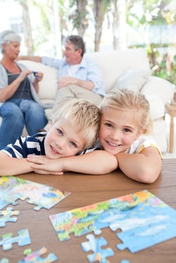Children playing with a puzzle instead of video game