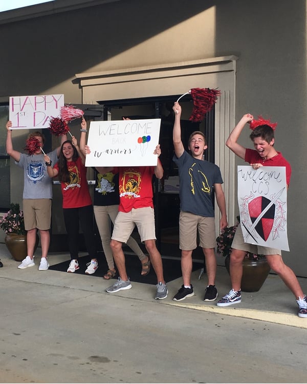 kids cheering outside of school