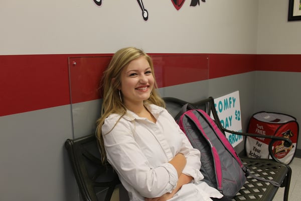 happy student beside backpack