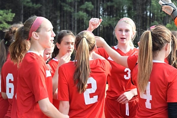 girls soccer team cheering