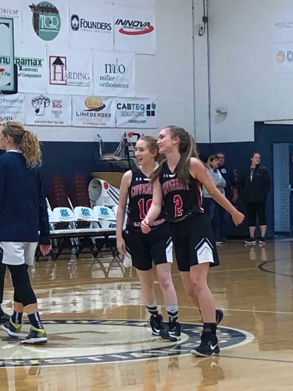 girls smiling playing basketball